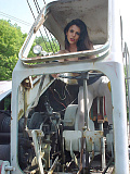 Eve Miller on an old excavator in light gray pantyhose without panties and skirt